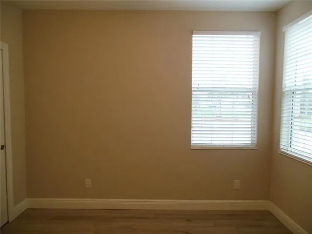 a view of a small space with wooden floor and a window