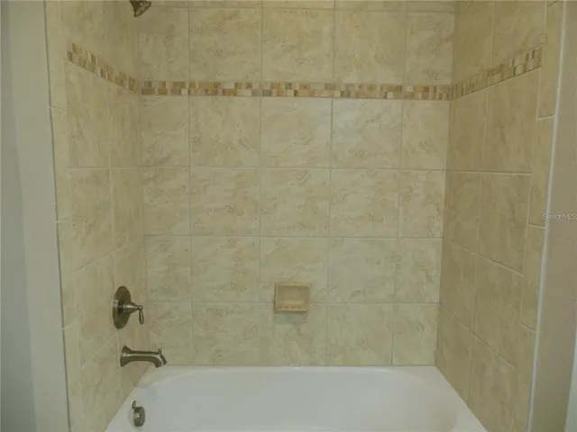 a bathroom with a shower and a bathtub