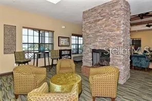 a room with pool table and windows