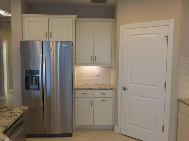 a kitchen with cabinets and stainless steel appliances