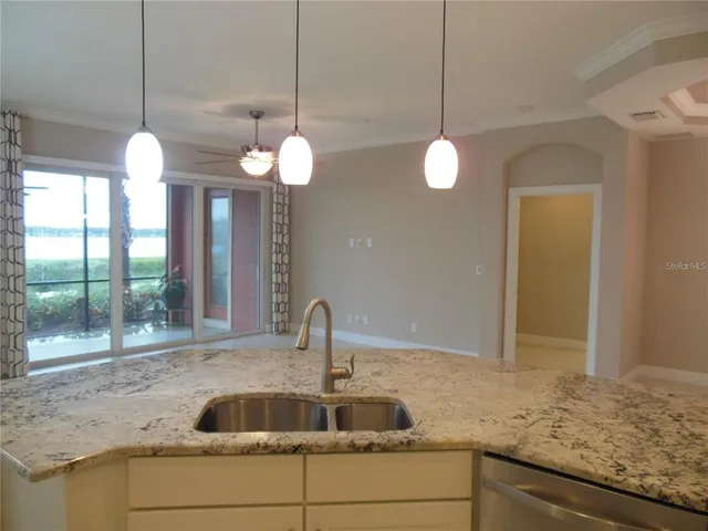 a kitchen with a sink and chandelier