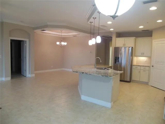 a kitchen with kitchen island a sink stainless steel appliances and cabinets