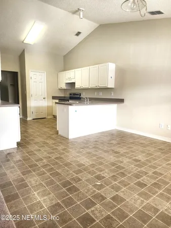a kitchen with granite countertop a sink and a stove