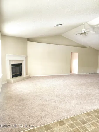 a view of an empty room with a fireplace