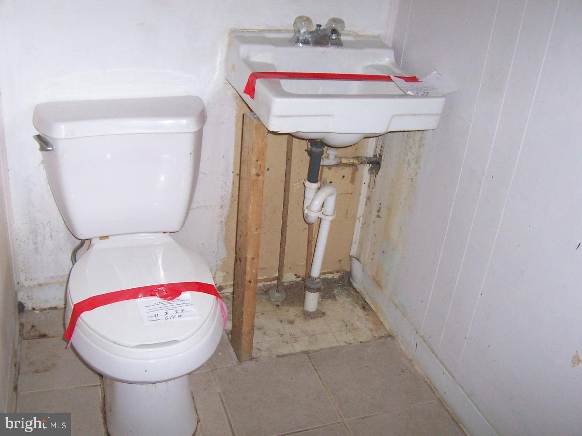 172 Boston Road Pennsville, NJ 08070 - Photo 8 of 8 a bathroom with a toilet and a mirror