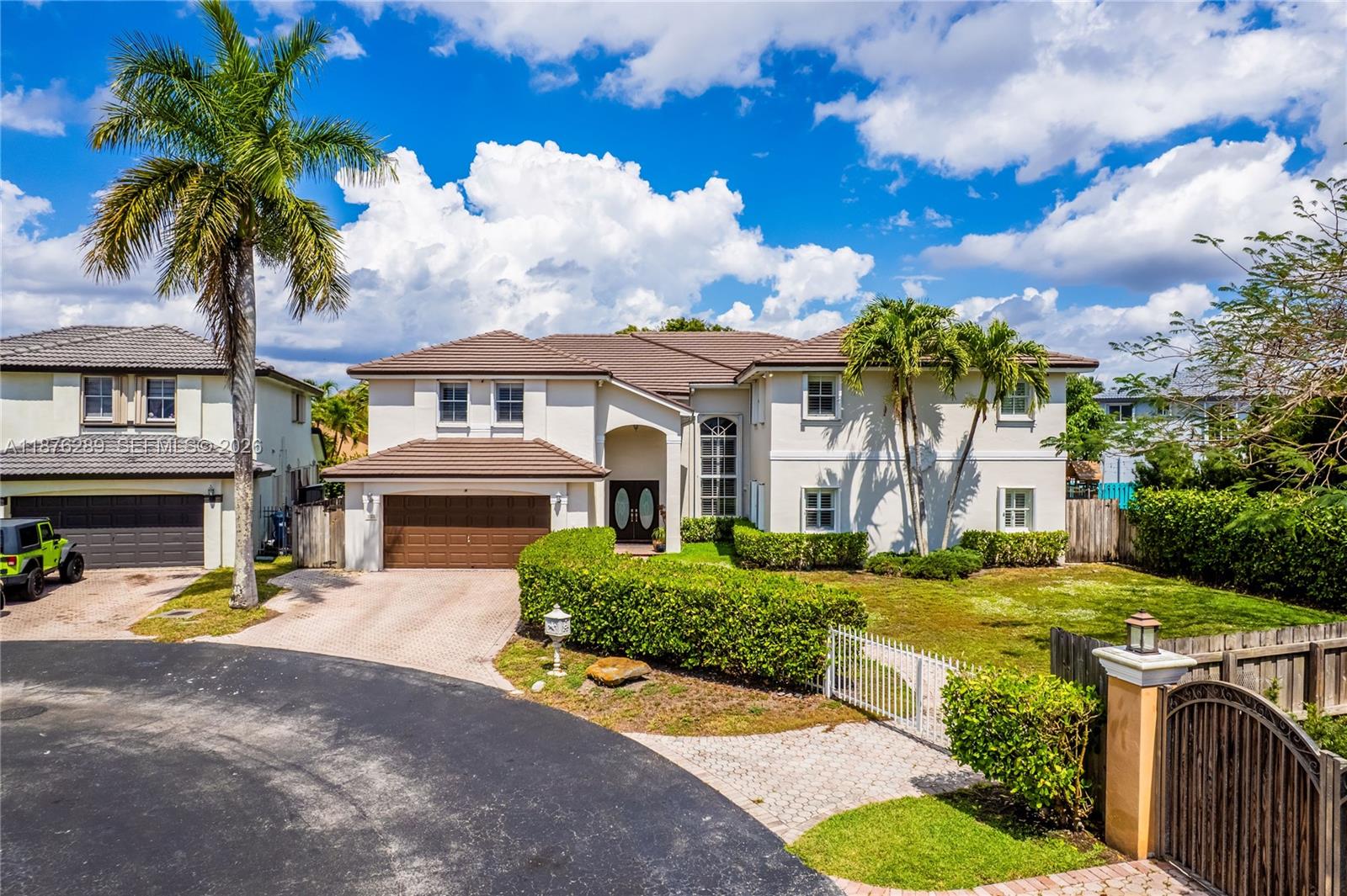 a front view of a house with swimming pool and porch