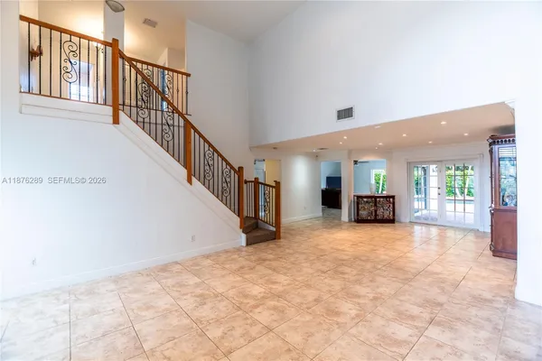 a kitchen with granite countertop a refrigerator stove top oven and sink