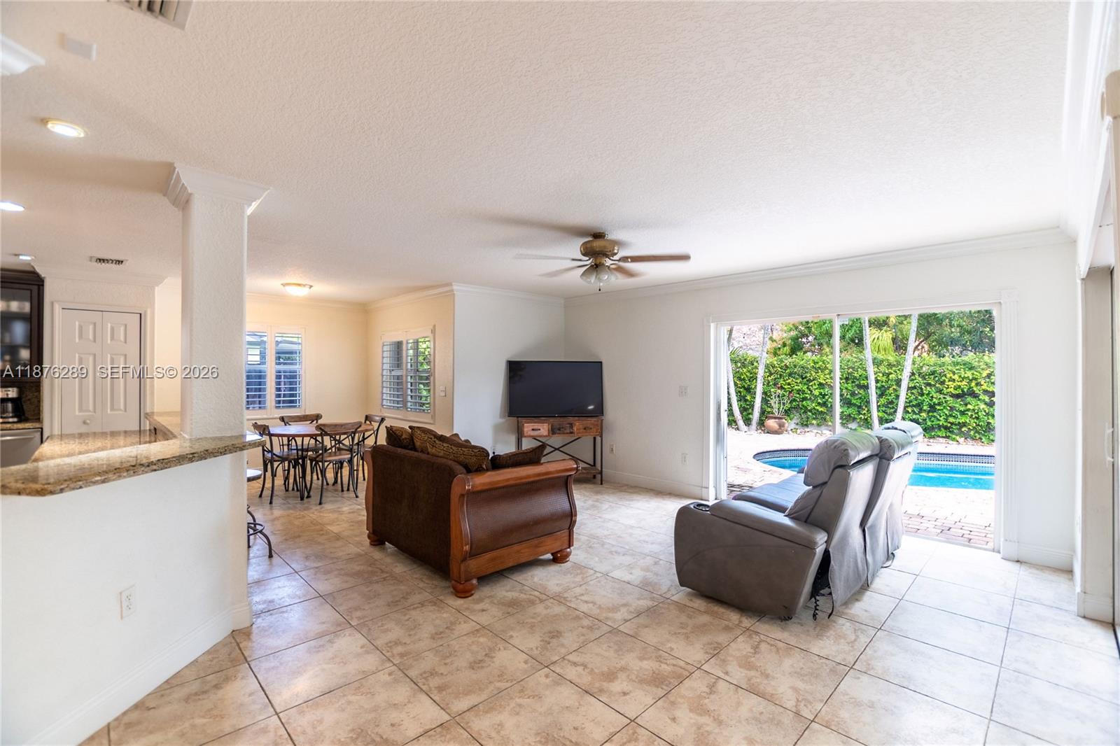 16335 Southwest 93rd Street Miami, FL 33196 - Photo 12 of 70 a living room with furniture and a flat screen tv