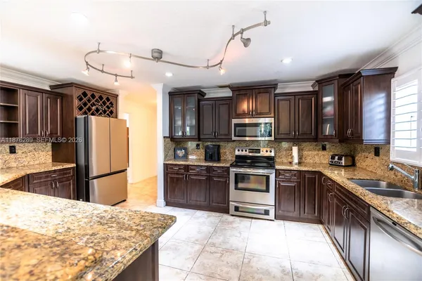 a living room with stainless steel appliances kitchen island granite countertop furniture and a kitchen view
