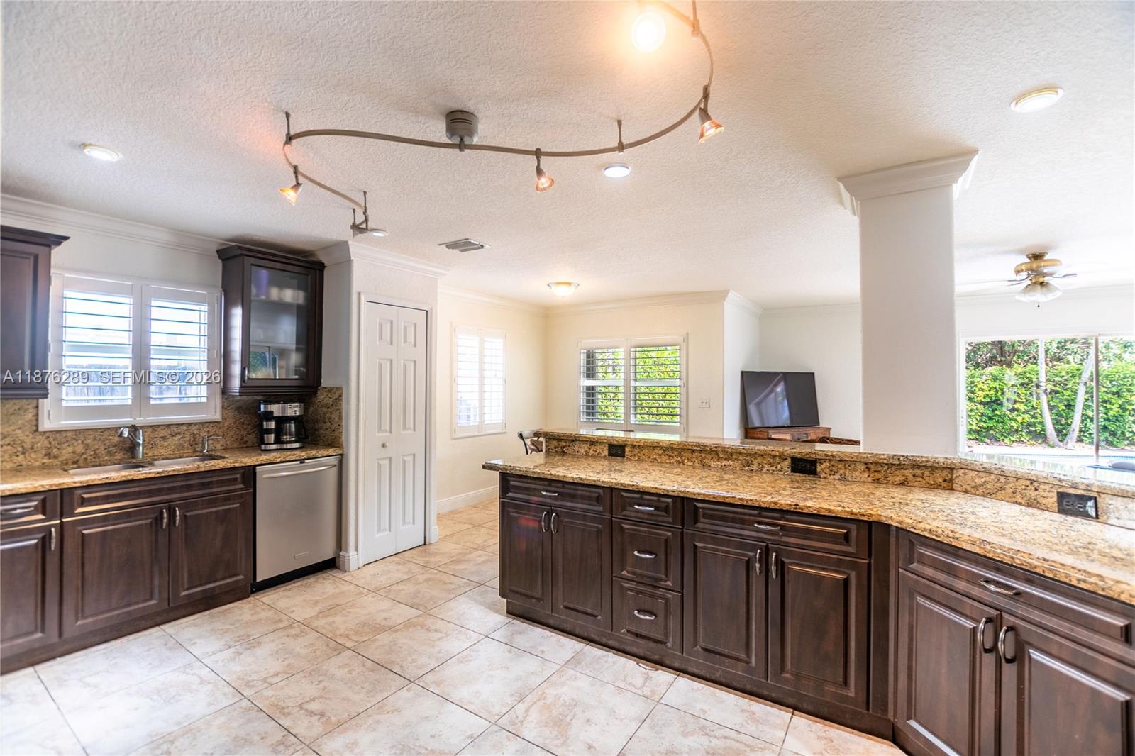 16335 Southwest 93rd Street Miami, FL 33196 - Photo 16 of 70 a large kitchen with a stove and sink