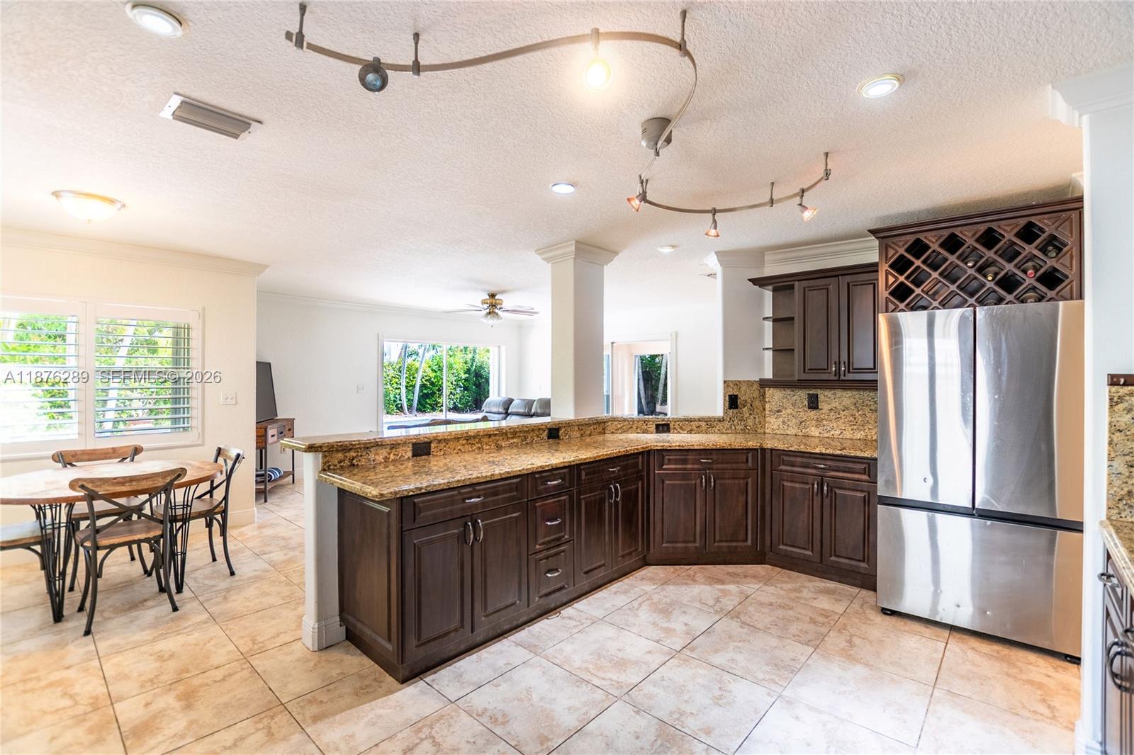 16335 Southwest 93rd Street Miami, FL 33196 - Photo 17 of 70 a kitchen with a sink a counter top stainless steel appliances and cabinets