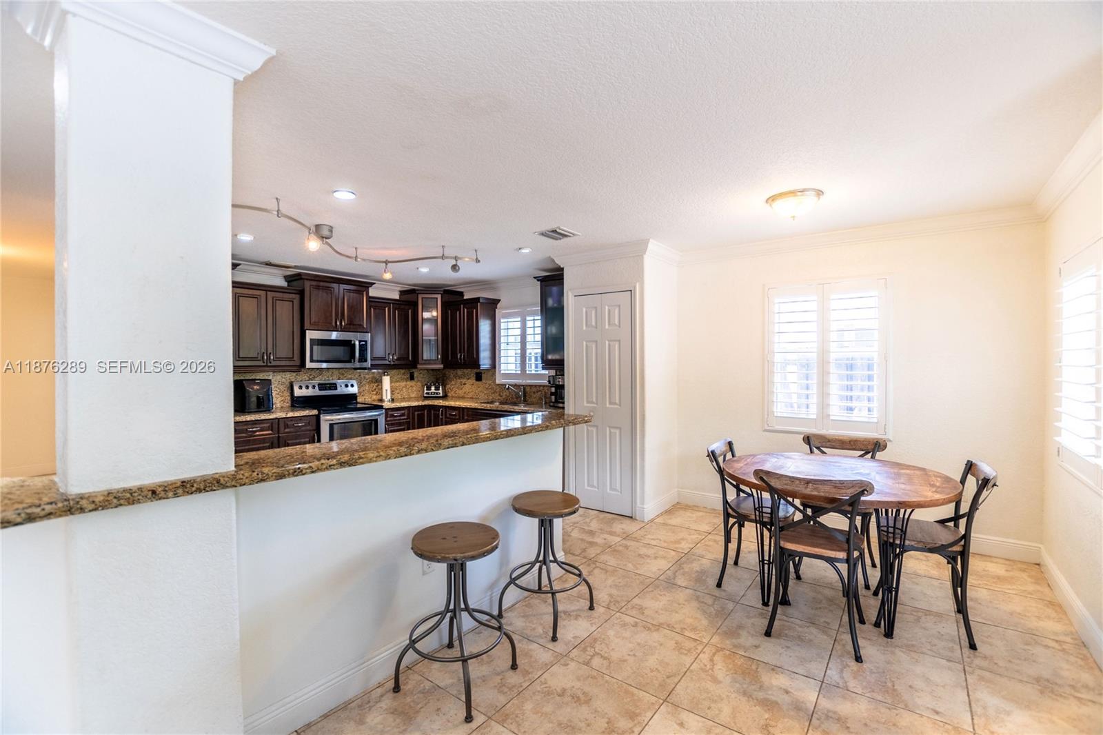 16335 Southwest 93rd Street Miami, FL 33196 - Photo 18 of 70 a view of a dining room with furniture