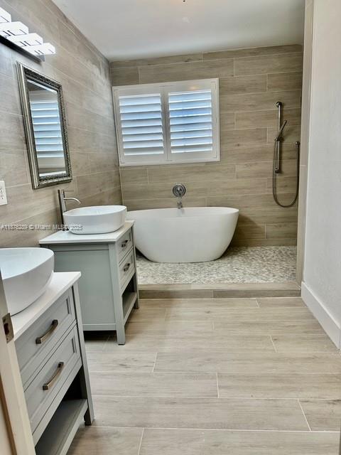 16335 Southwest 93rd Street Miami, FL 33196 - Photo 19 of 29 a bathroom with a granite countertop sink and a bathtub