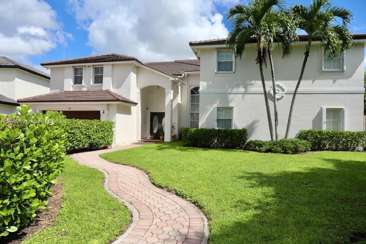 16335 Southwest 93rd Street Miami, FL 33196 - Photo 2 of 29 a front view of a house with a yard