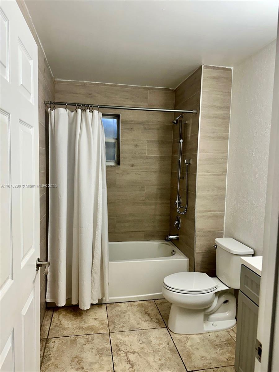 16335 Southwest 93rd Street Miami, FL 33196 - Photo 24 of 29 a bathroom with a toilet and a shower