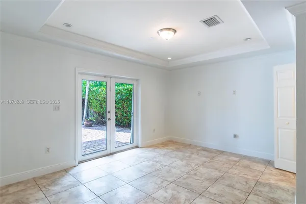 a view of a hallway with a livingroom and a bathroom