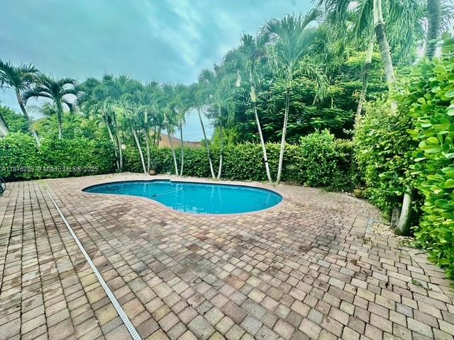 16335 Southwest 93rd Street Miami, FL 33196 - Photo 27 of 29 a view of a swimming pool with a yard