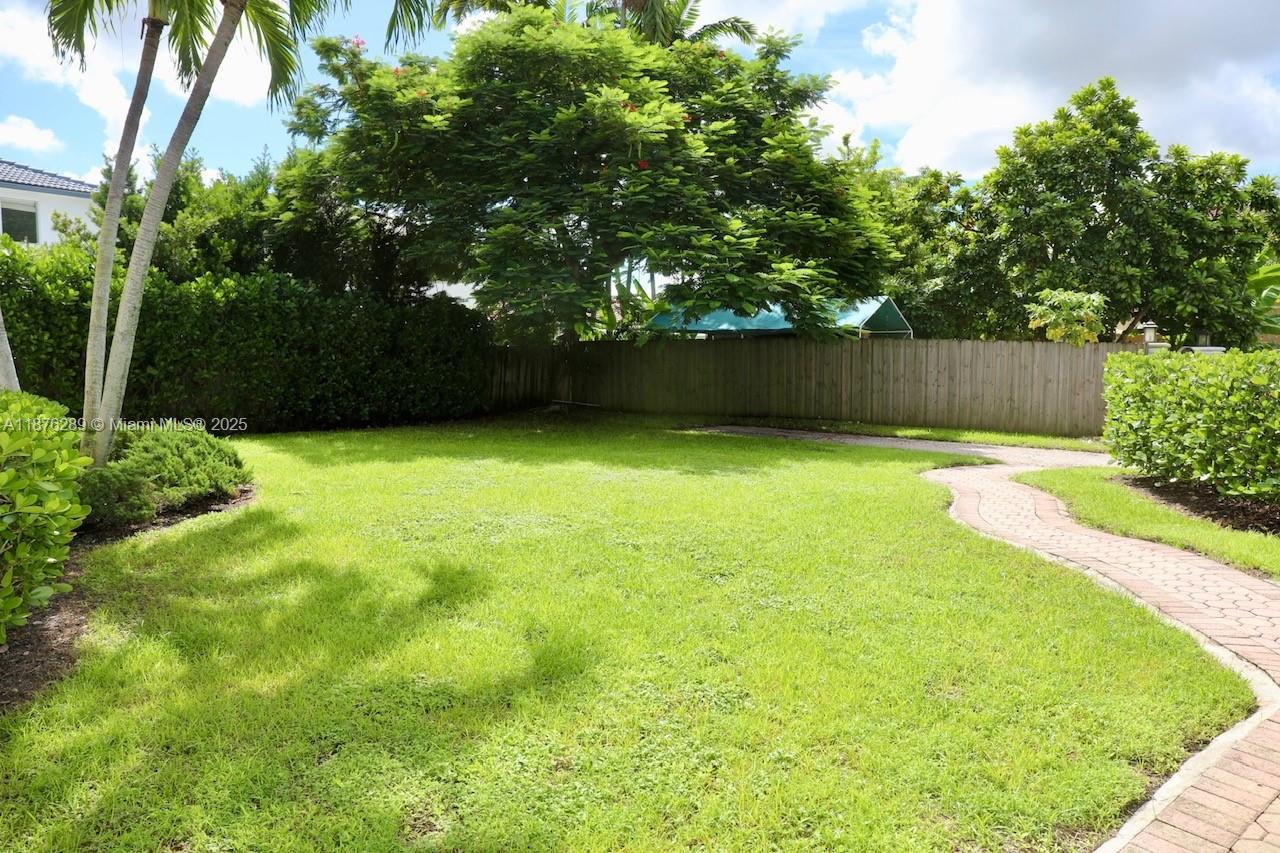 16335 Southwest 93rd Street Miami, FL 33196 - Photo 3 of 29 a swimming pool with wooden fence
