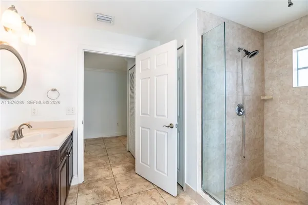 a bathroom with a sink toilet a mirror and shower