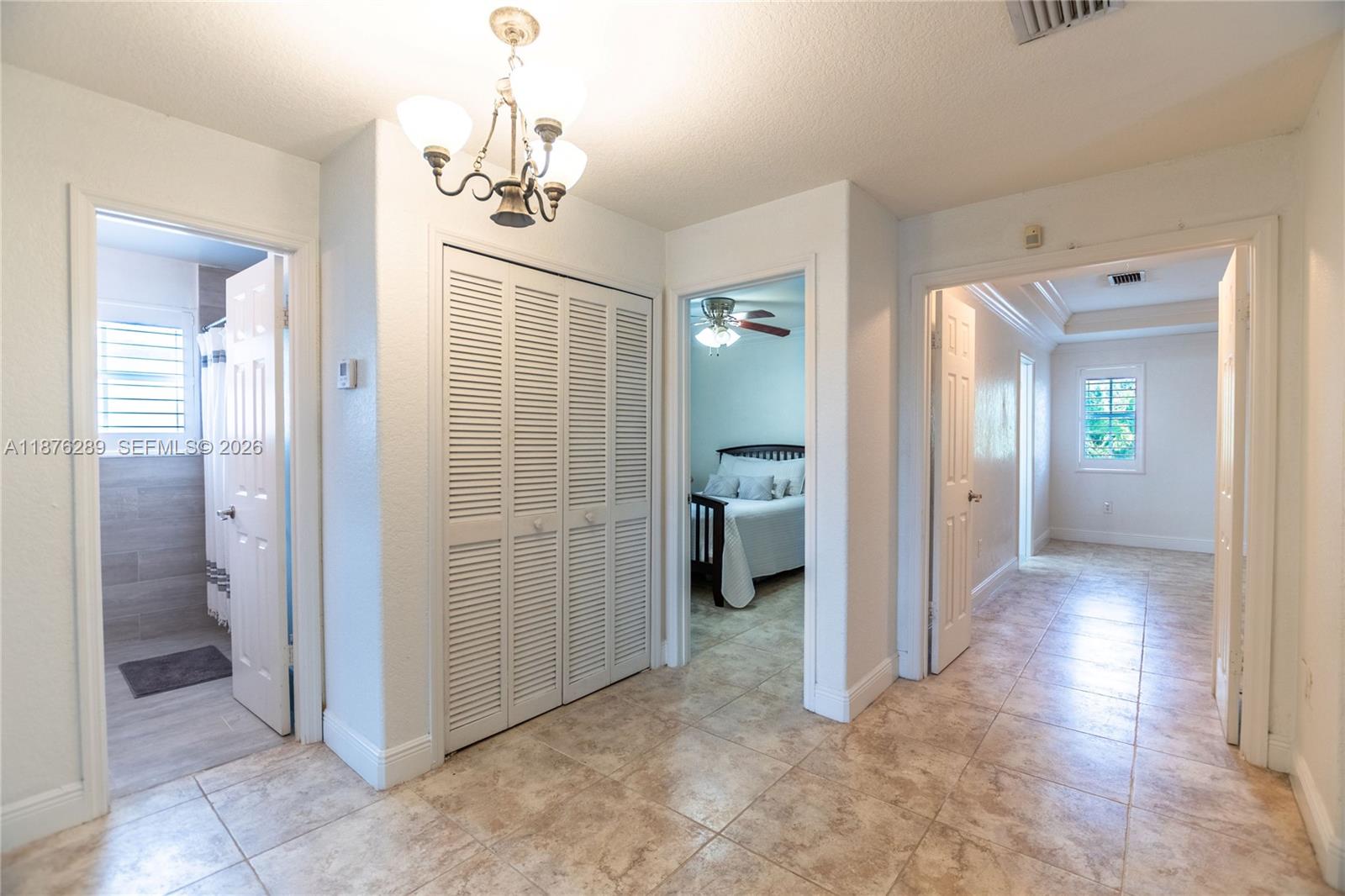 16335 Southwest 93rd Street Miami, FL 33196 - Photo 37 of 70 a view of a hallway with a livingroom and a bathroom
