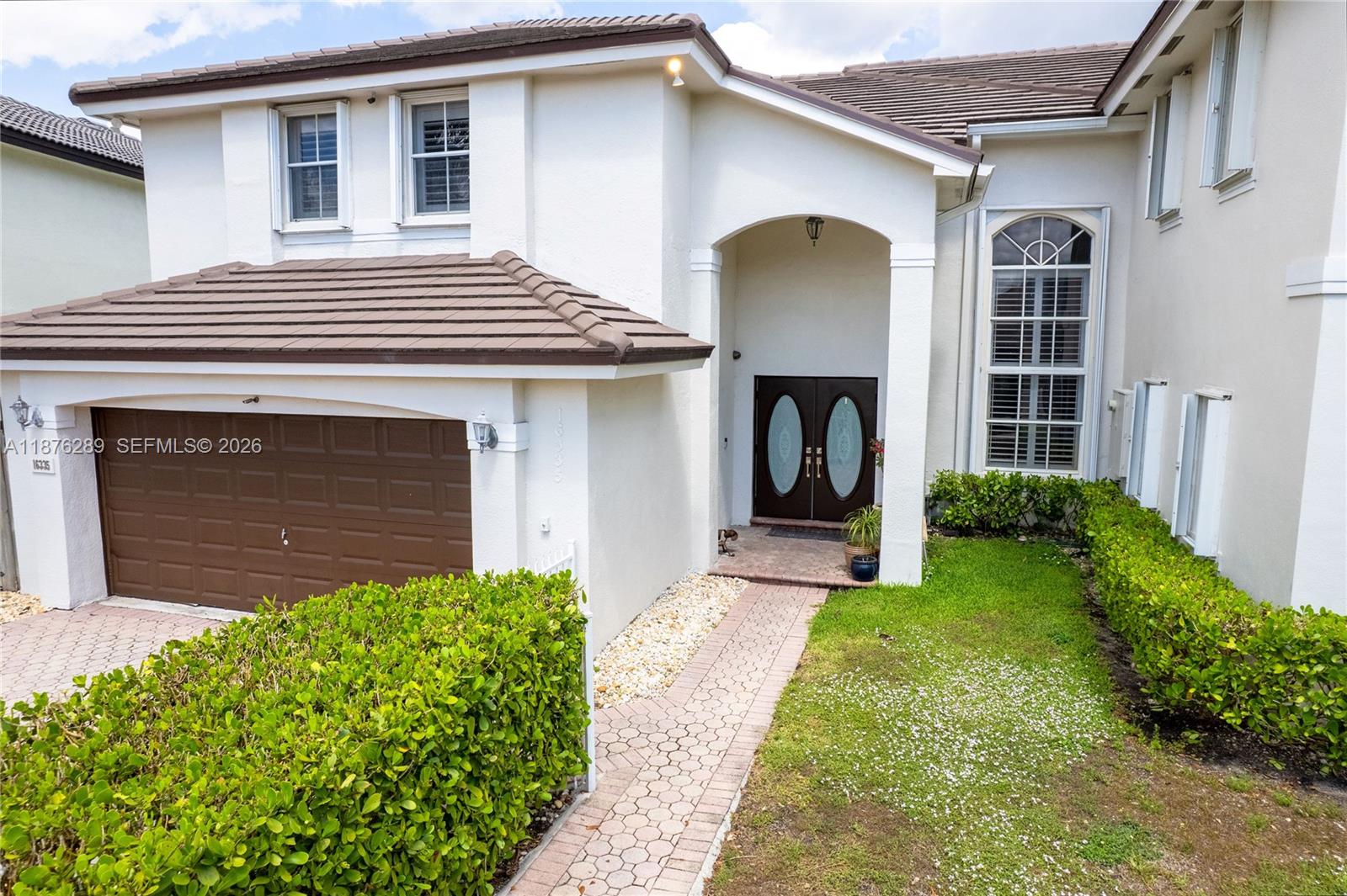 16335 Southwest 93rd Street Miami, FL 33196 - Photo 4 of 70 a front view of a house with garden