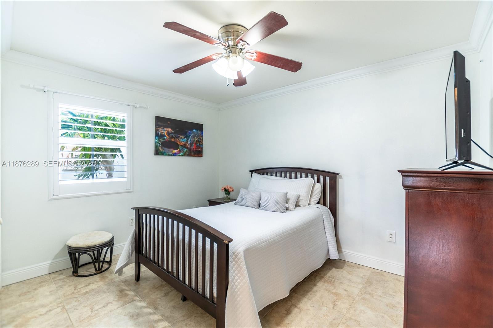 16335 Southwest 93rd Street Miami, FL 33196 - Photo 42 of 70 a bedroom with a bed and a chandelier