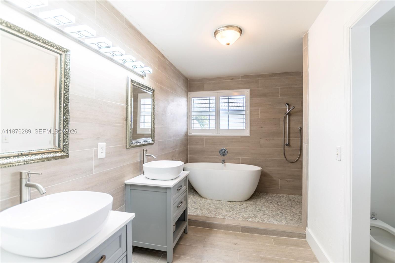 16335 Southwest 93rd Street Miami, FL 33196 - Photo 45 of 70 a bathroom with a sink and mirror