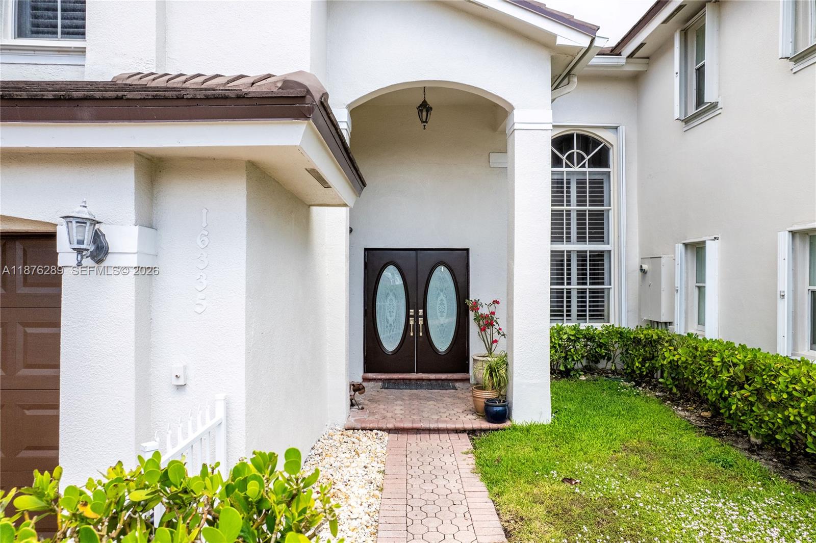 16335 Southwest 93rd Street Miami, FL 33196 - Photo 5 of 70 a front view of a house with a yard