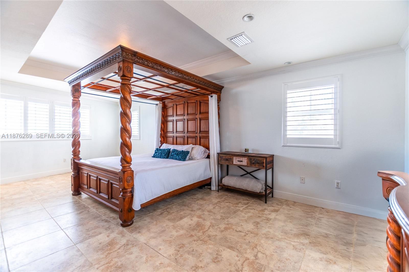 16335 Southwest 93rd Street Miami, FL 33196 - Photo 55 of 70 a spacious bedroom with a bed and a window