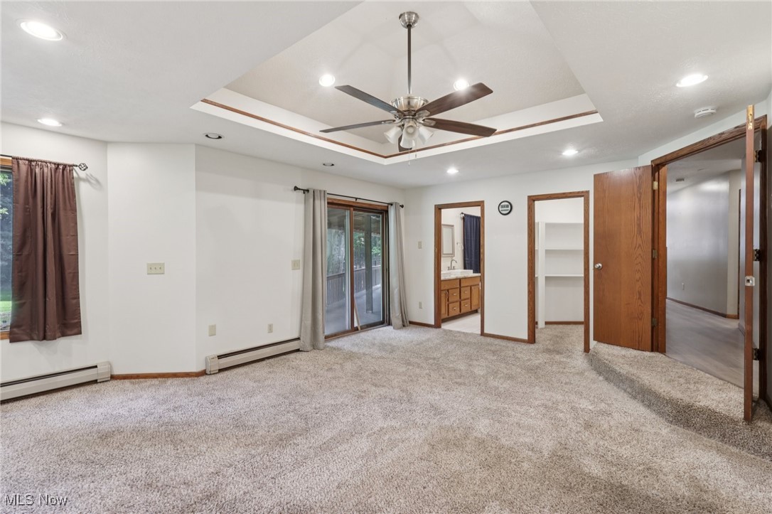 5643 Chapin Road Madison, OH 44057 - Photo 35 of 50 Unfurnished bedroom with baseboard heating, a tray ceiling, light colored carpet, and recessed lighting