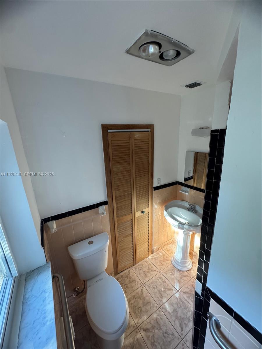 3021 Southwest 2nd Avenue Miami, FL 33129 - Photo 23 of 29 a bathroom with a toilet and a mirror