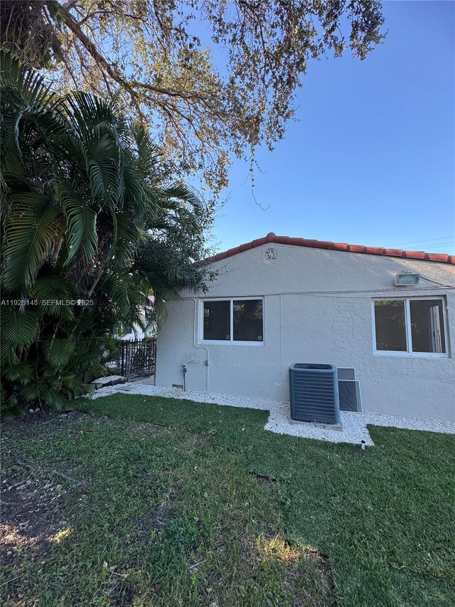 3021 Southwest 2nd Avenue Miami, FL 33129 - Photo 29 of 29 a backyard of a house with plants and large tree