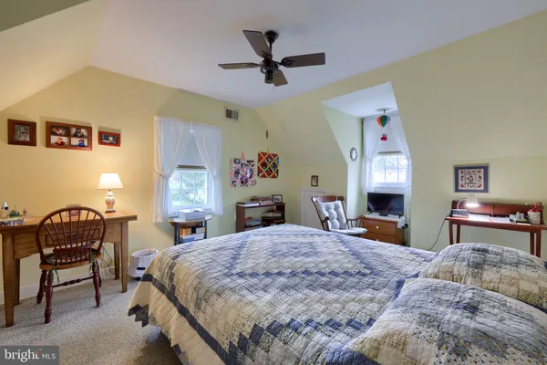 a bedroom with a bed and a chair
