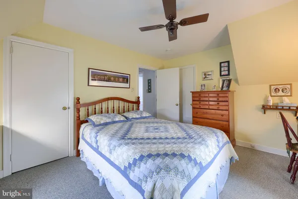 a bedroom with a bed and dresser
