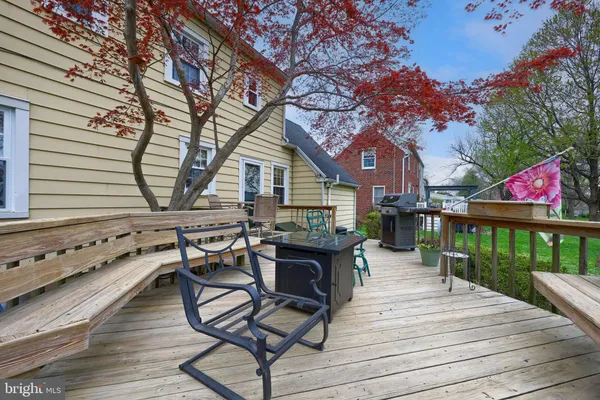 a view of a deck with chairs and wooden fence