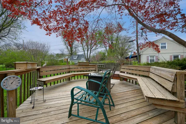 a view of a chairs and table on the wooden deck