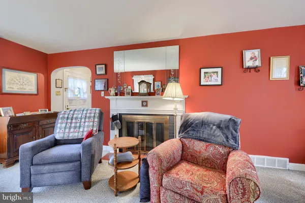 a living room with furniture fireplace and a flat screen tv