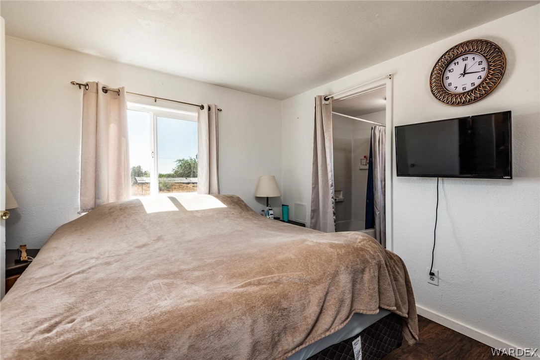 3535 Mobile Road Golden Valley, AZ 86413 - Photo 12 of 37 a bedroom with a bed and a television