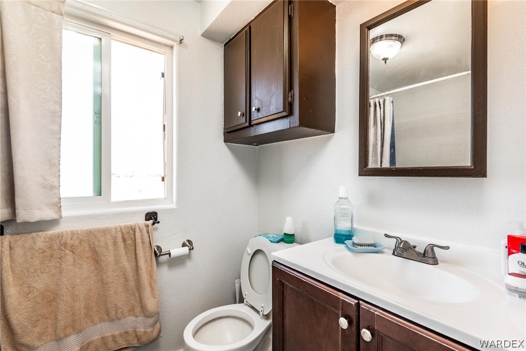 3535 Mobile Road Golden Valley, AZ 86413 - Photo 14 of 37 a bathroom with a sink and a toilet