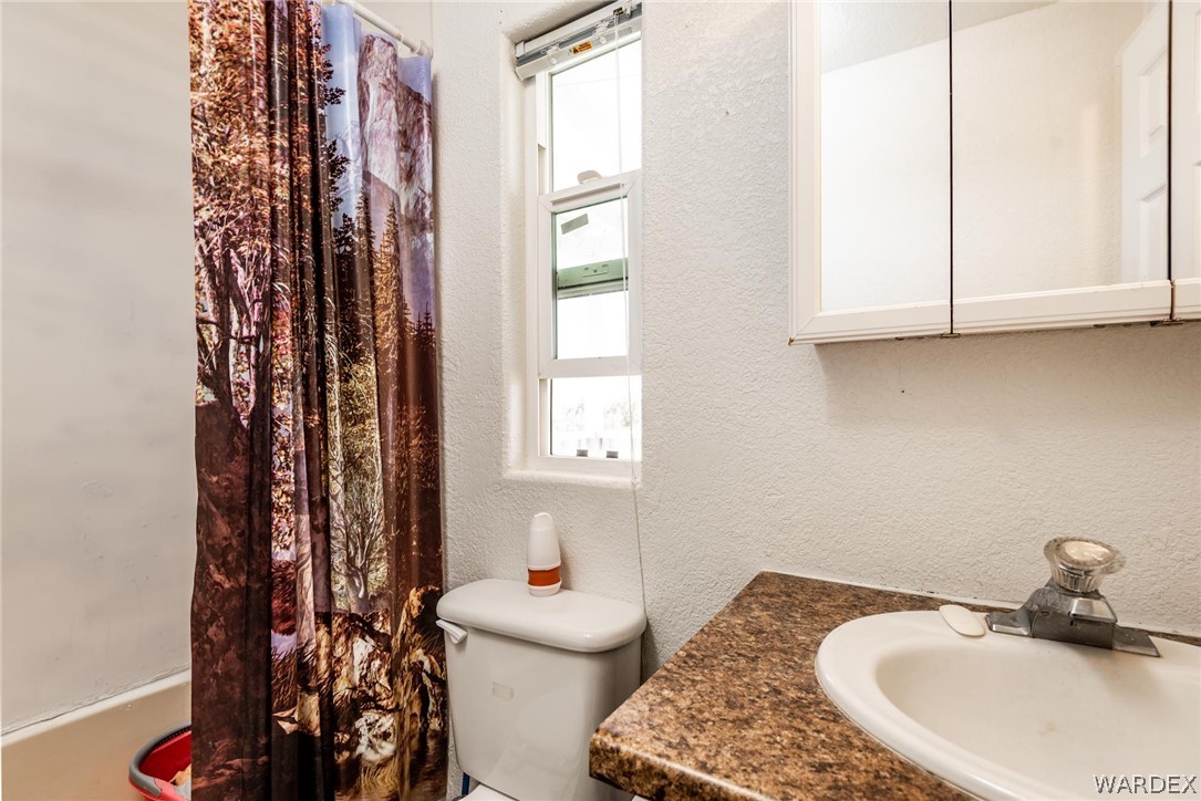 3535 Mobile Road Golden Valley, AZ 86413 - Photo 20 of 37 a bathroom with a sink toilet and a mirror