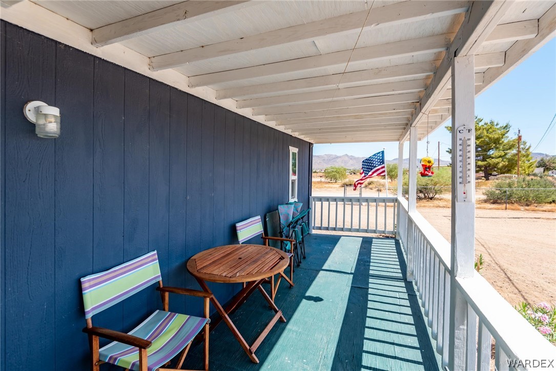 3535 Mobile Road Golden Valley, AZ 86413 - Photo 27 of 37 a balcony with wooden floor table and chairs