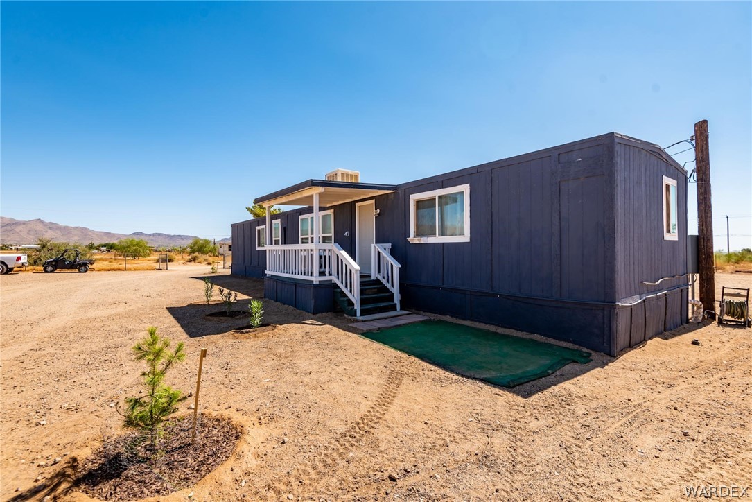 3535 Mobile Road Golden Valley, AZ 86413 - Photo 33 of 37 a view of a house with wooden floor and a yard