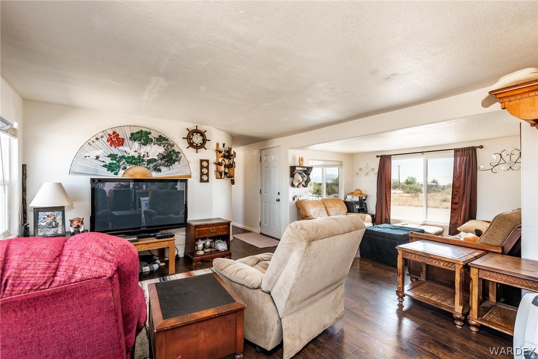 3535 Mobile Road Golden Valley, AZ 86413 - Photo 6 of 37 a living room with furniture a flat screen tv and a floor to ceiling window