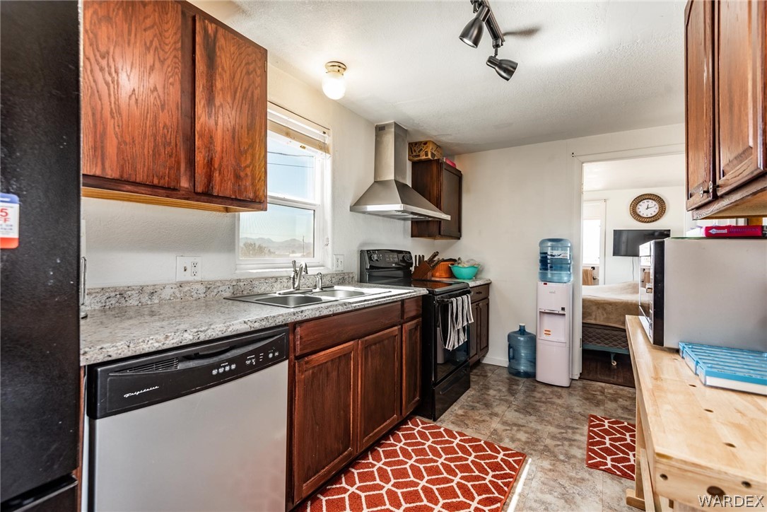 3535 Mobile Road Golden Valley, AZ 86413 - Photo 8 of 37 a kitchen with stainless steel appliances granite countertop a sink stove and refrigerator