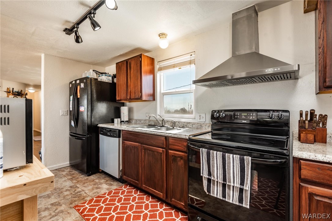 3535 Mobile Road Golden Valley, AZ 86413 - Photo 9 of 37 a kitchen with stainless steel appliances granite countertop a stove and a refrigerator