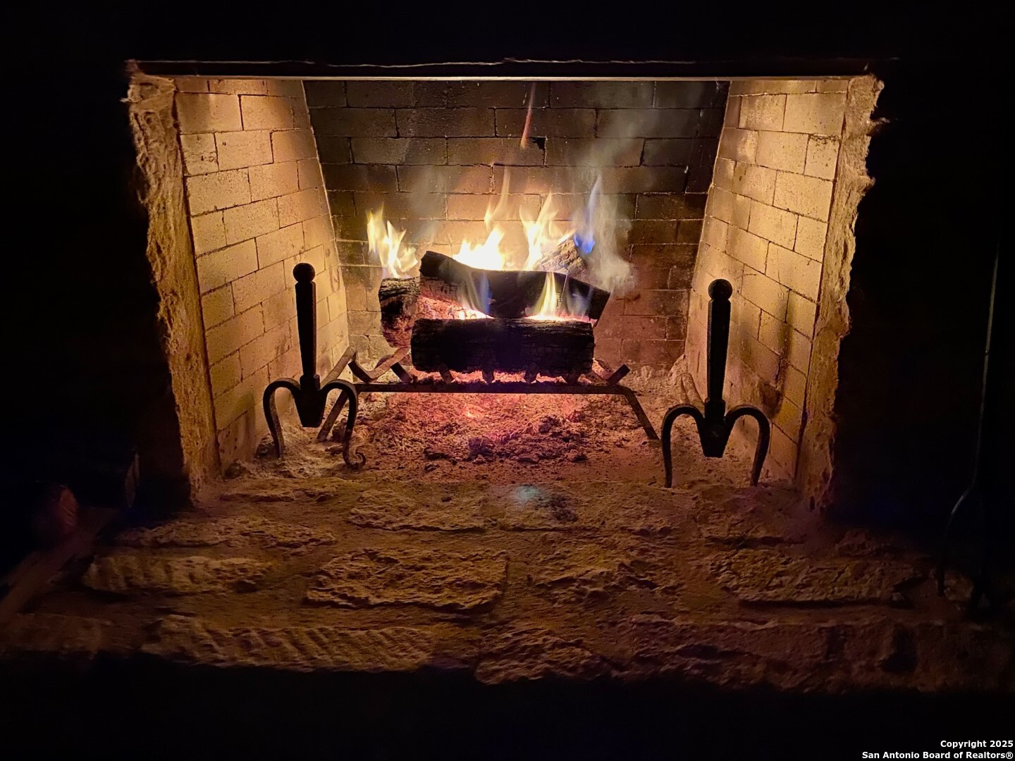512 County Road 348 Concan, TX 78838 - Photo 26 of 39 a view of a fireplace with an outdoor space