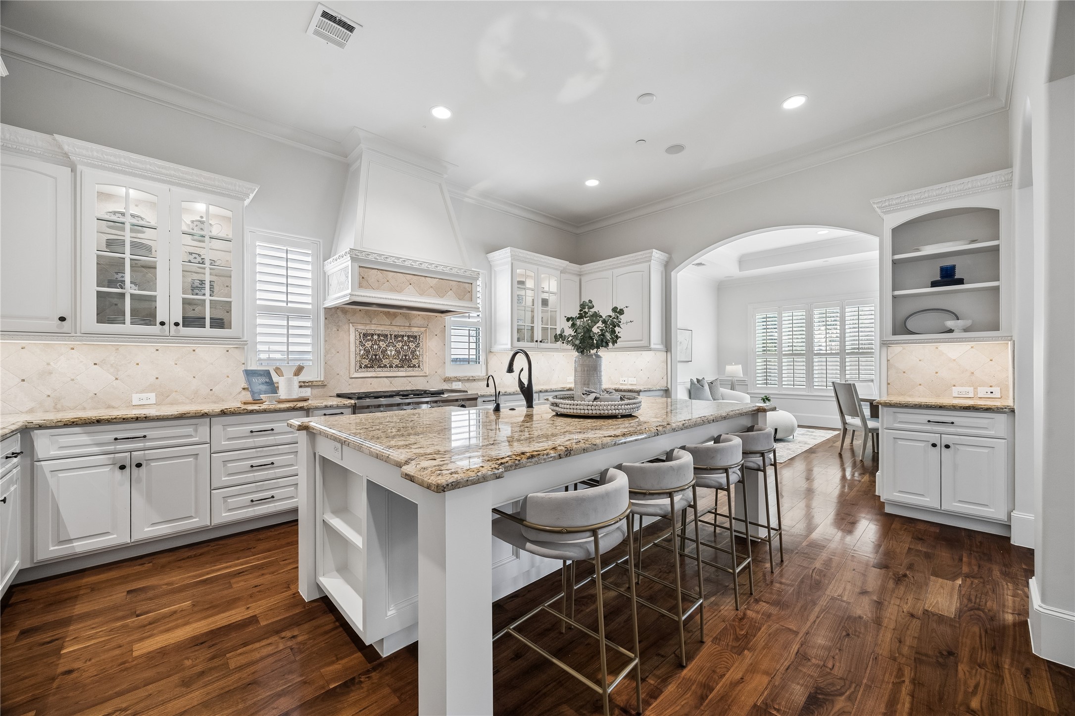 4511 Merrie Lane Bellaire, TX 77401 - Photo 20 of 49 a kitchen with stainless steel appliances granite countertop hardwood floor sink stove dining table and chairs
