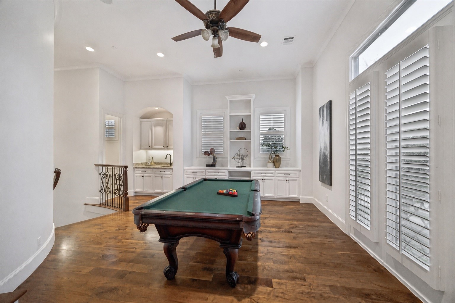 4511 Merrie Lane Bellaire, TX 77401 - Photo 27 of 49 Game room with custom built-ins and abundant natural light. A half bath is off to the left