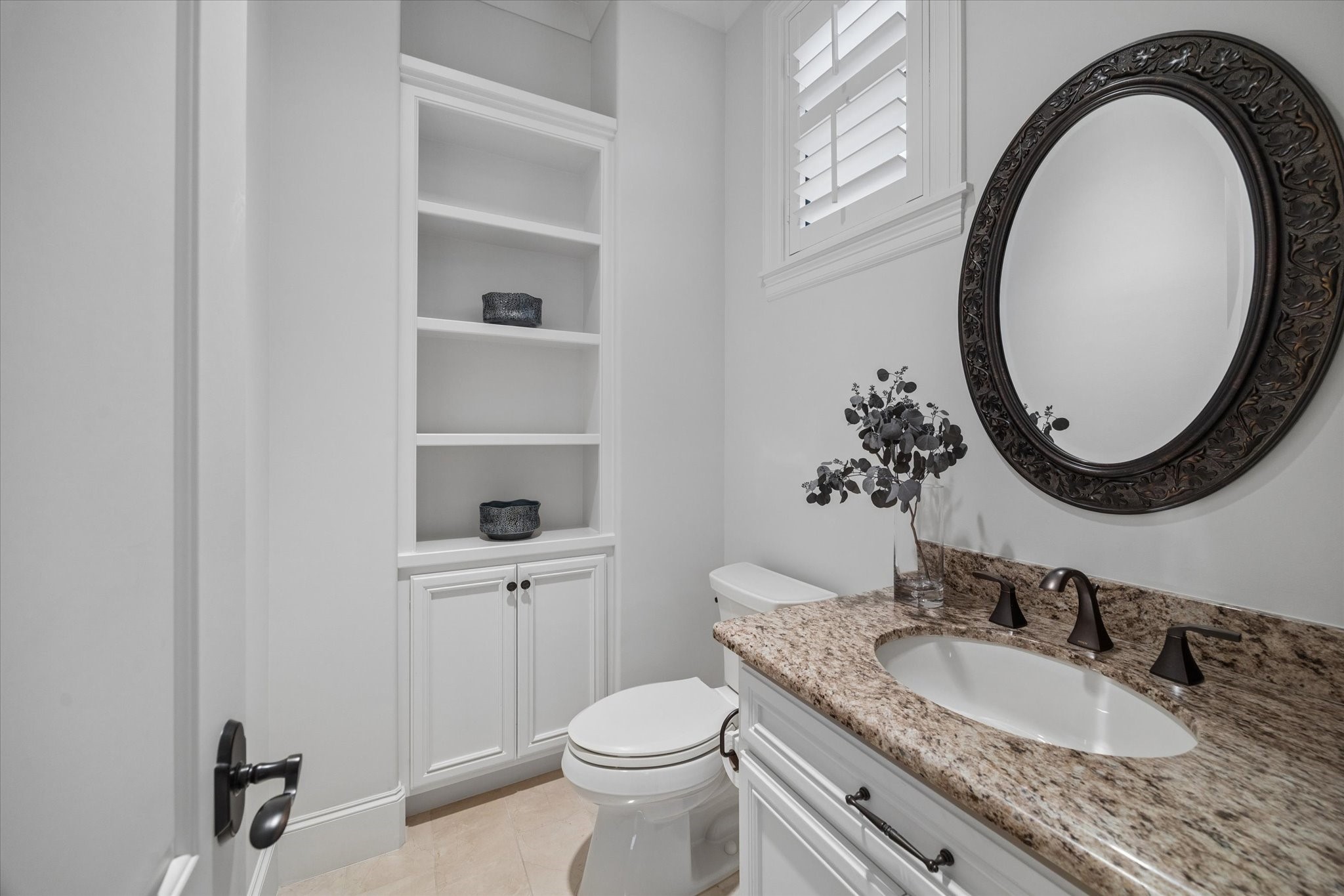 4511 Merrie Lane Bellaire, TX 77401 - Photo 30 of 49 a bathroom with a granite countertop toilet a sink and a mirror