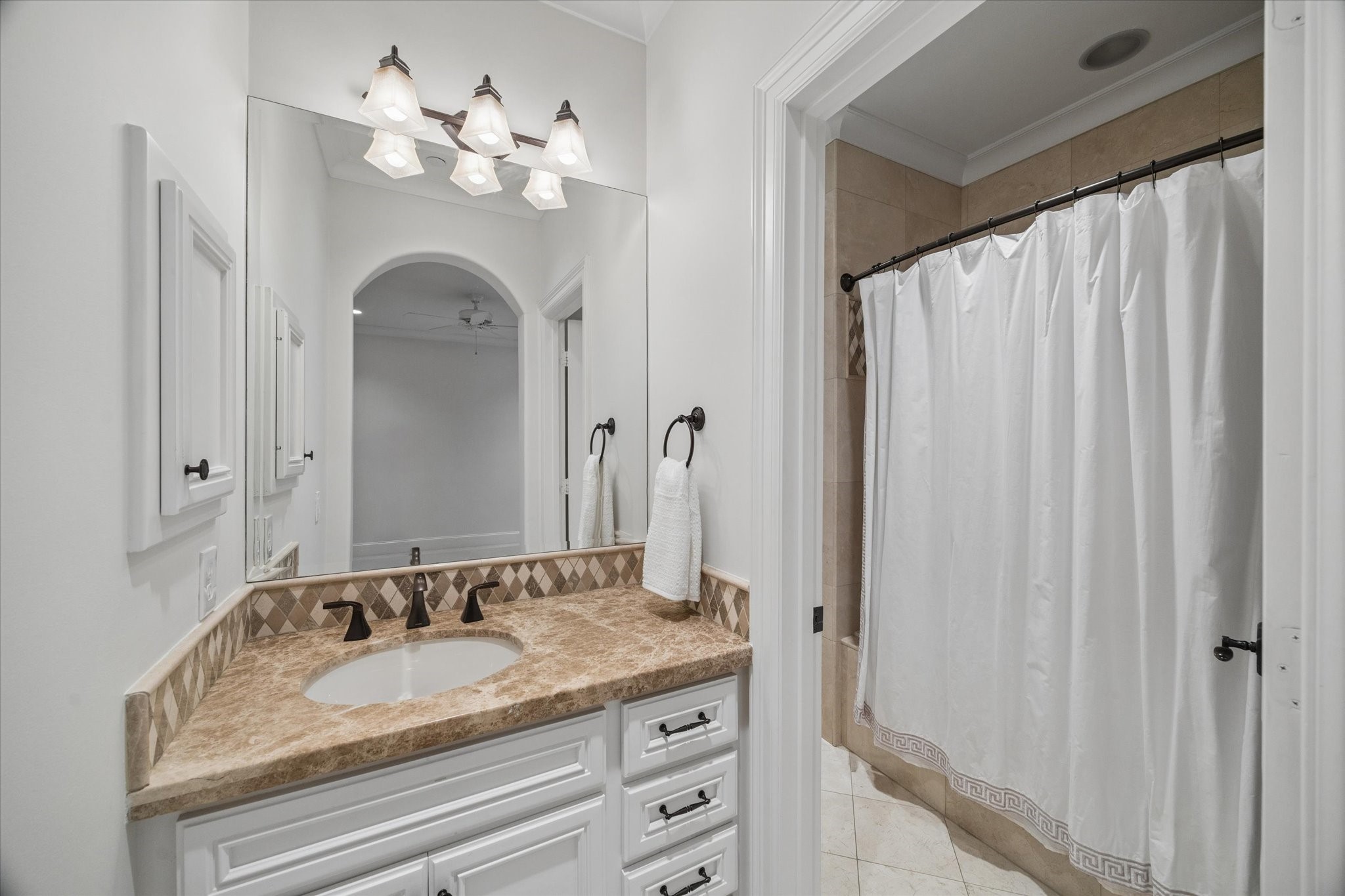 4511 Merrie Lane Bellaire, TX 77401 - Photo 38 of 49 a bathroom with a granite countertop sink and a mirror